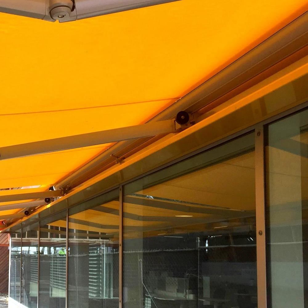 Recess Folding Arm Awning extended over an outdoor space