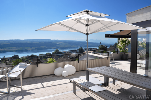 Supremo umbrella from Caravita shading an outdoor living area