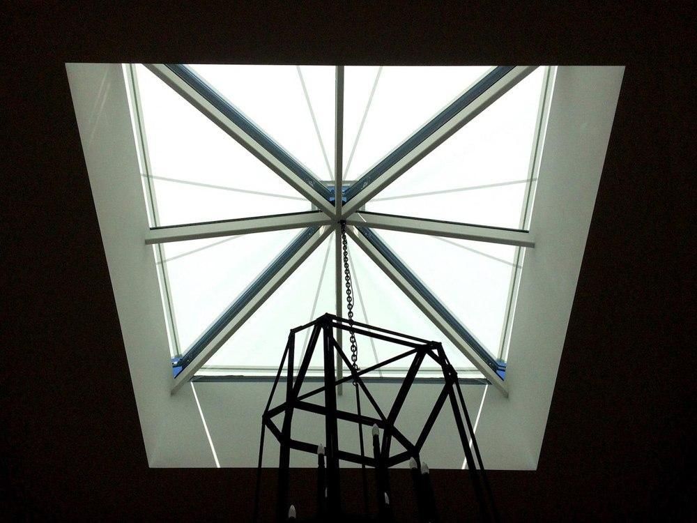 Worm eye view of D3 Conservatory awnings installed over a glass roof