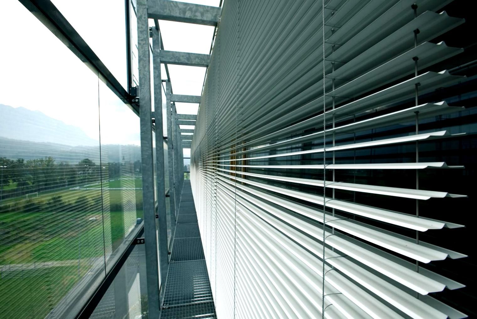 Daylight guidance blinds installed on the side of a commercial building