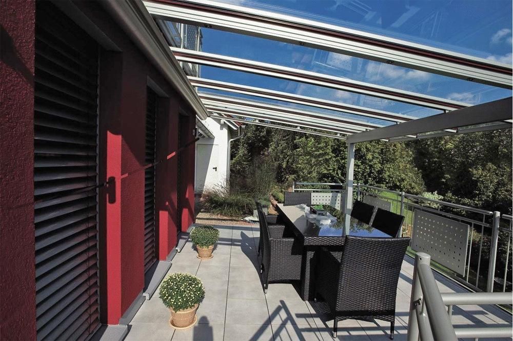W10 Climara Conservatory Awning retracted over an outdoor entertainment area