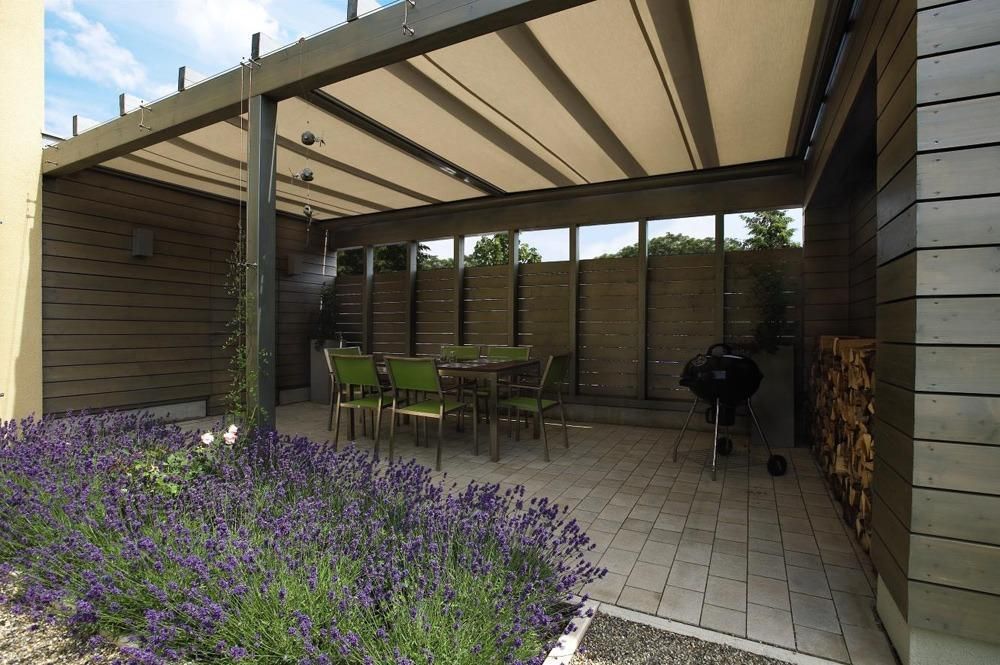 W10 Climara Conservatory Awning extended over an outdoor entertainment area