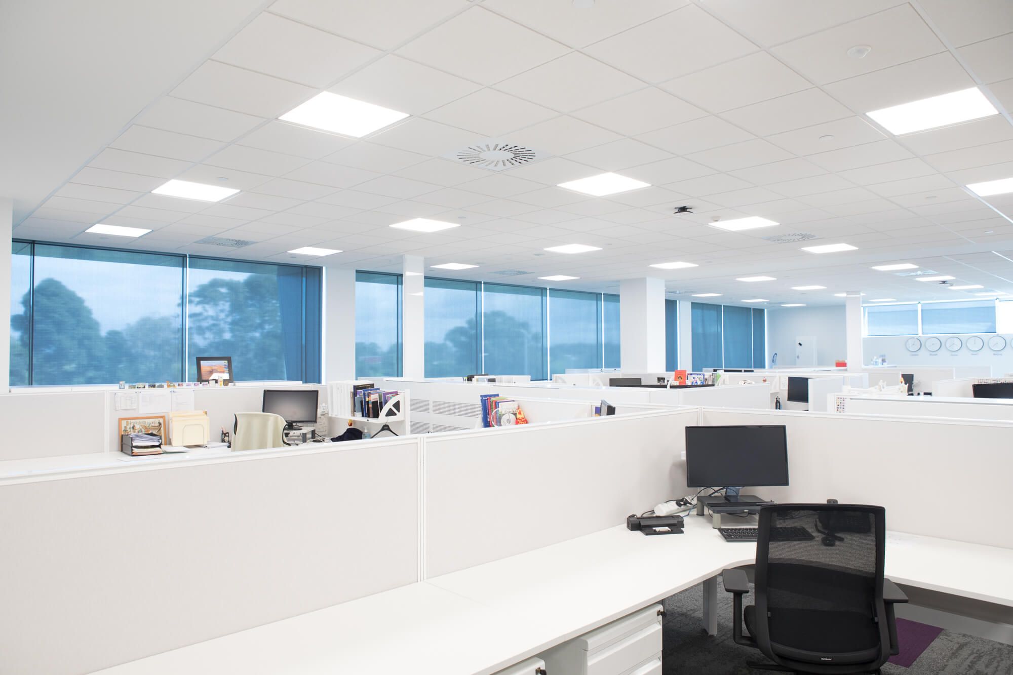 Internal roller blinds providing shade for an office space