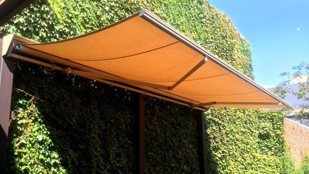 Terrea Folding Arm awning providing shade in an outdoor space