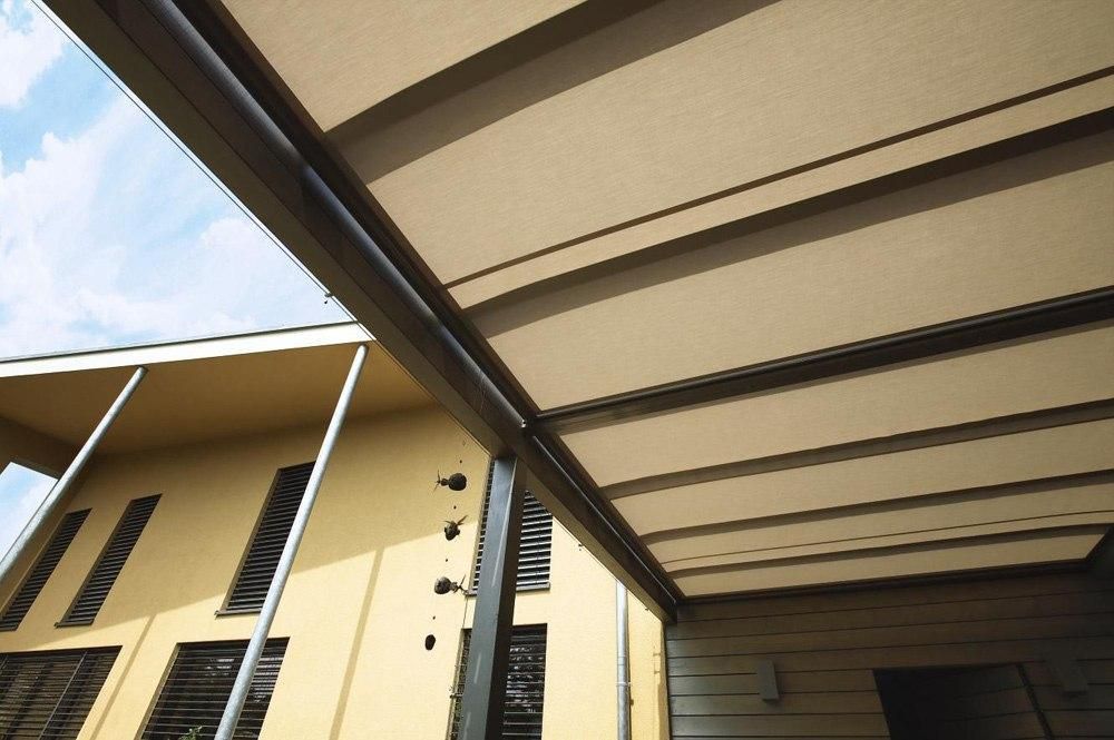 Worm's eye view of a W10 Climara Conservatory Awning extended over an outdoor entertainment area