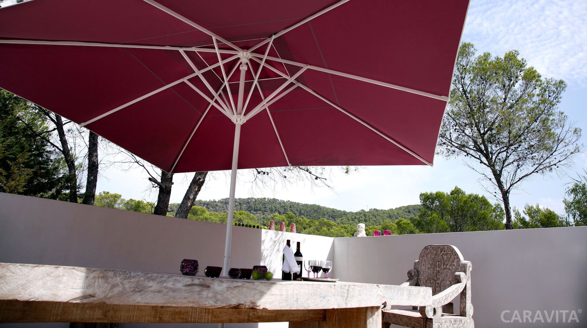 Samara umbrella from Caravita shading an outdoor dining area