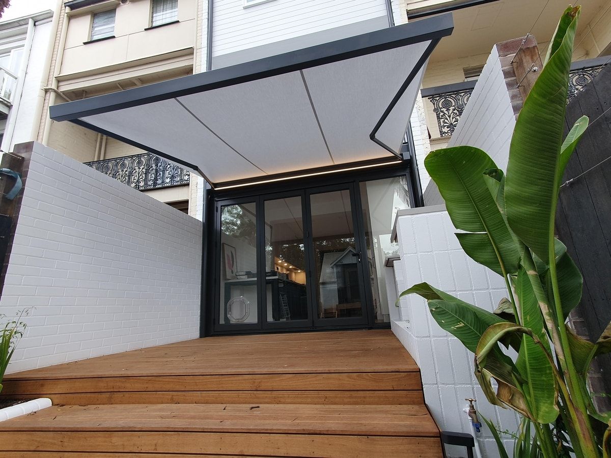 K50 Cassette awning extended out over outdoor terrace of a modern home