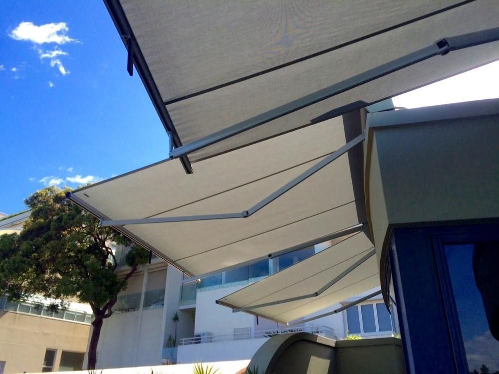 Terrea Folding Arm awning providing shade for an outdoor area
